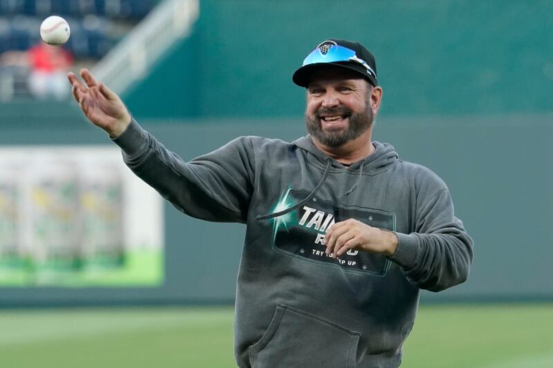 KANSAS CITY, MISSOURI - AUGUST 29: Country artist Garth Brooks throws out the first pitch prior to a game between the Pittsburgh Pirates and Kansas City Royals at Kauffman Stadium on August 29, 2023 in Kansas City, Missouri. (Photo by Ed Zurga/Getty Images)