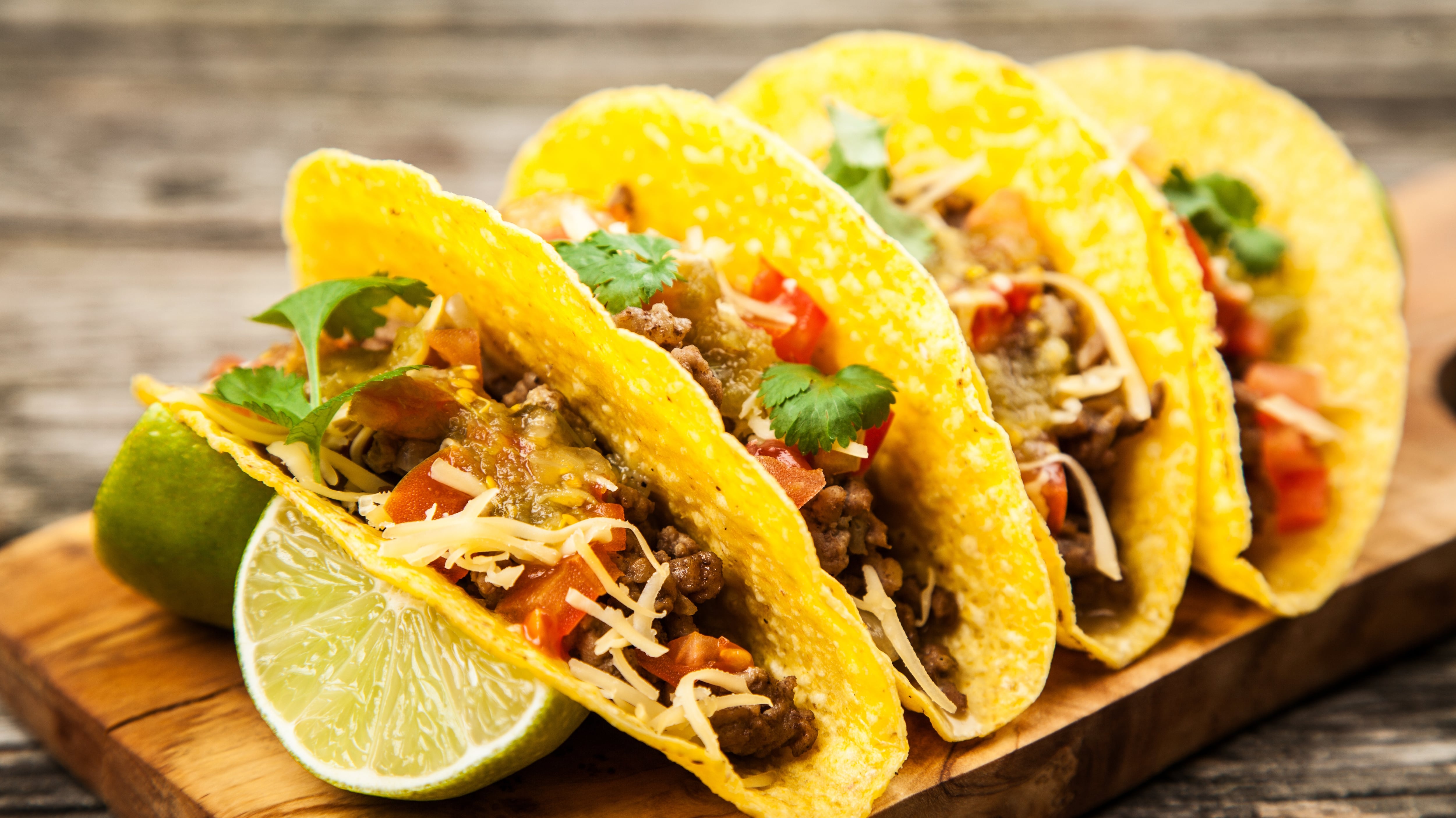 Tacos with beef, cheese, tomato and green salsa