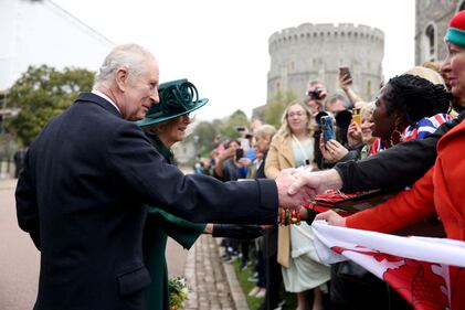 WINDSOR, ENGLAND - MARCH 31: King Charles III and Queen Camilla greet people after attending the Easter Matins Service at St. George's Chapel, Windsor Castle, on March 31, 2024 in Windsor, England. (Photo by Hollie Adams - WPA Pool/Getty Images)