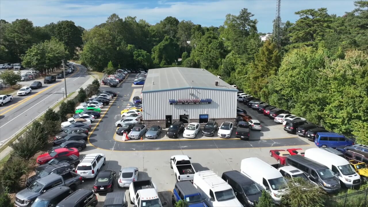 An aerial view shows a used car lot.