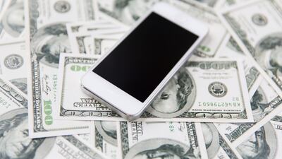business, finance, technology and e-commerce concept - close up of smartphone with black blank screen and dollar money