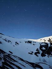 In this image provided by the Alpine Rescue Team, lamps are illuminated on a ridge as Alpine Rescue Team members take part in helping get two men struck by lightning off Torreys Peak in Colorado, Thursday, June 12, 2025. (Jake Smith/Alpine Rescue Team via AP)